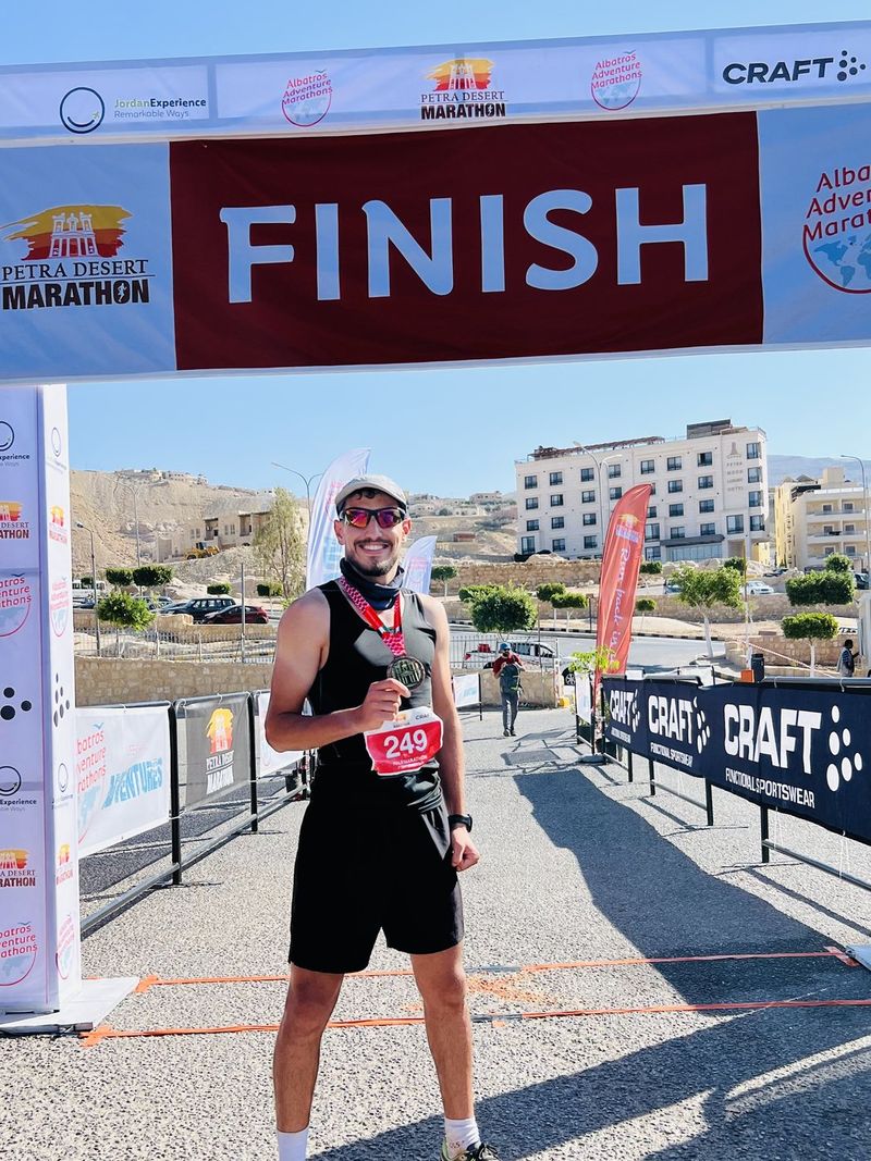Fuad Abu Safi at the Petra Desert Marathon finish arch in Jordan